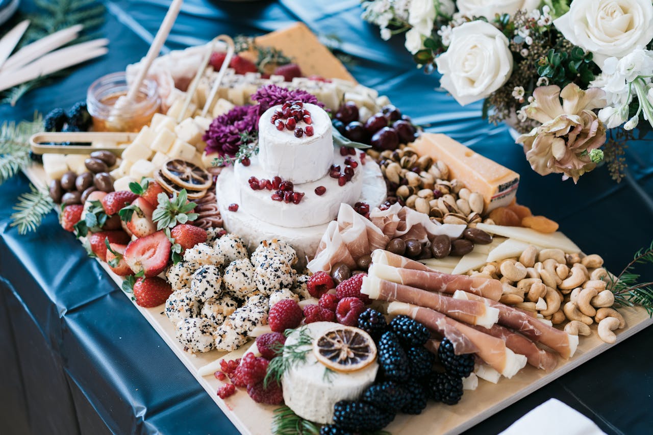 A beautifully arranged charcuterie board featuring gourmet cheese, nuts, olives, and fresh fruits, perfect for gatherings.