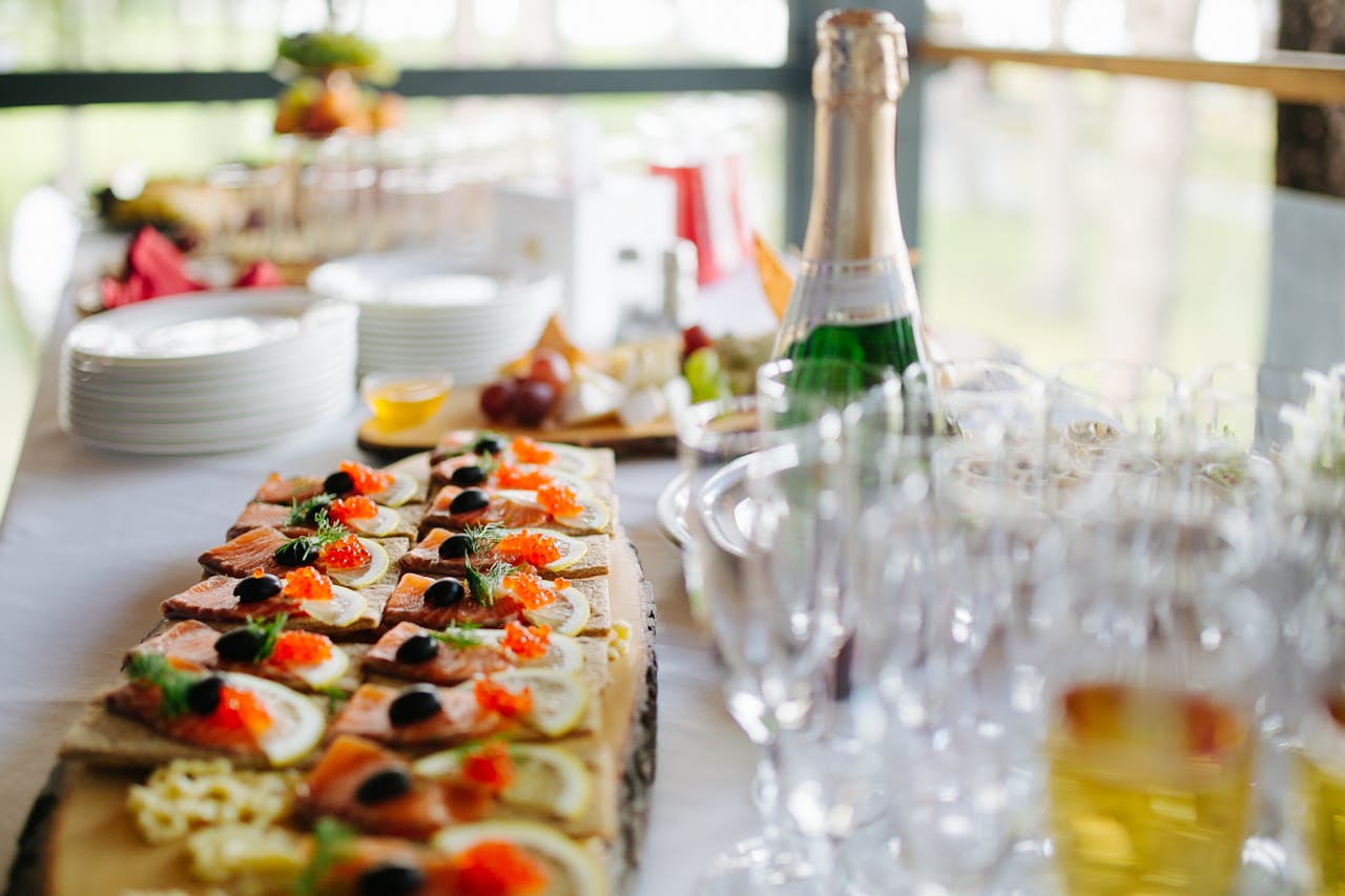 Platter of gourmet appetizers served with champagne for a stylish event.